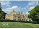 Stately brick mansion with manicured lawn and beautiful architectural details at 5353 Chipwood Ln, Indianapolis, IN 46226