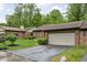 Well-maintained brick home with attached garage, lush lawn and mature trees at 5353 Chipwood Ln, Indianapolis, IN 46226