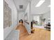 Hallway with hardwood flooring, skylight, and access to the living room at 5353 Chipwood Ln, Indianapolis, IN 46226