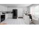 Efficient kitchen with white cabinets, black appliances, and a cozy breakfast nook at 5353 Chipwood Ln, Indianapolis, IN 46226