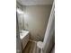 Well-lit half bathroom featuring modern fixtures and stylish design elements at 5735 Liberty Creek E Dr, Indianapolis, IN 46254