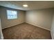 This bedroom features neutral walls, carpeted floors, and a bright window at 5735 Liberty Creek E Dr, Indianapolis, IN 46254