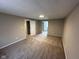 Bedroom features neutral walls, carpeted floors, and two doorways leading into other rooms at 5735 Liberty Creek E Dr, Indianapolis, IN 46254