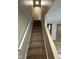 Carpeted staircase with white banister leading to the upper level of the home at 5735 Liberty Creek E Dr, Indianapolis, IN 46254
