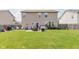 Spacious backyard featuring a well-maintained lawn, patio seating, and privacy fence at 5913 Monticello Square Ln, Indianapolis, IN 46234