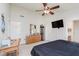 A bedroom with a ceiling fan, wood dresser, and television; perfect for relaxation and comfort at 5913 Monticello Square Ln, Indianapolis, IN 46234