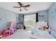 Bright bedroom with light blue walls, a white bed and playful decor, creating a fun and inviting space at 5913 Monticello Square Ln, Indianapolis, IN 46234