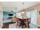 Dining area with a high table and bar stool seating, with views into the living room at 5913 Monticello Square Ln, Indianapolis, IN 46234
