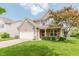 Charming two-story home featuring a two-car garage, well-manicured lawn, and inviting front porch at 5913 Monticello Square Ln, Indianapolis, IN 46234