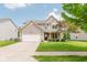 Charming two-story home featuring a two-car garage, well-manicured lawn, and inviting front porch at 5913 Monticello Square Ln, Indianapolis, IN 46234