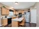 Well-appointed kitchen featuring wood cabinets, stainless steel appliances, island, and modern finishes at 5913 Monticello Square Ln, Indianapolis, IN 46234