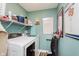 Well-organized laundry room features modern washer and dryer with shelving and décor at 5913 Monticello Square Ln, Indianapolis, IN 46234