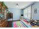 Bright room with light blue walls, hardwood floors, window, and area for children to play at 5913 Monticello Square Ln, Indianapolis, IN 46234