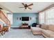 Comfortable living room with a large sectional couch, ceiling fan, hardwood floors, and a wall-mounted TV at 5913 Monticello Square Ln, Indianapolis, IN 46234