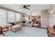 Comfortable living room with a large sectional couch, hardwood floors, and natural light streaming in from the windows at 5913 Monticello Square Ln, Indianapolis, IN 46234