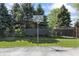 Community basketball court with well-maintained black fencing and surrounding green trees at 601 Conner Creek Dr, Fishers, IN 46038