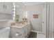Bright bathroom features a vanity with a large mirror and Hollywood style vanity lighting at 601 Conner Creek Dr, Fishers, IN 46038