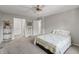A large bedroom is furnished with a bed, neutral carpet, and a ceiling fan at 601 Conner Creek Dr, Fishers, IN 46038