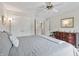 A bright bedroom has a ceiling fan, natural light, and a gray comforter at 601 Conner Creek Dr, Fishers, IN 46038