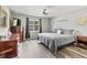 A cozy bedroom features wood floors, neutral walls, ceiling fan, and natural light from the window at 601 Conner Creek Dr, Fishers, IN 46038