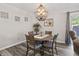 Cozy dining area featuring a round table, wood floors, and a stylish chandelier, with a sliding door to the outdoors at 601 Conner Creek Dr, Fishers, IN 46038