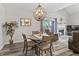 Charming dining area featuring a round table, stylish chandelier, fireplace, and sliding door to the outdoors at 601 Conner Creek Dr, Fishers, IN 46038