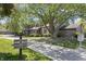 Neighborhood street view of townhome with lush trees, green space, and visible address marker at 601 Conner Creek Dr, Fishers, IN 46038