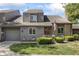 Charming townhome featuring a well-manicured lawn, lovely landscaping, and an attached one-car garage at 601 Conner Creek Dr, Fishers, IN 46038