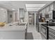 Well-lit kitchen with a breakfast bar, stainless appliances, and a view into the laundry room at 601 Conner Creek Dr, Fishers, IN 46038