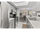 Bright kitchen area featuring stainless steel appliances and a passthrough to a dining area, ideal for entertaining at 601 Conner Creek Dr, Fishers, IN 46038