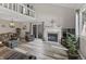 Bright living room with a cozy fireplace, modern flooring, and lots of natural light at 601 Conner Creek Dr, Fishers, IN 46038