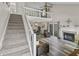 Open-concept living room featuring a staircase to a loft, fireplace, and sliding glass doors at 601 Conner Creek Dr, Fishers, IN 46038