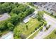 Aerial view of home, garage, and large lot with mature trees and landscaping at 606 E County Line Rd, Indianapolis, IN 46227