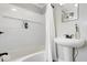Well-lit bathroom featuring a tub/shower combo with a white pedestal sink at 606 E County Line Rd, Indianapolis, IN 46227