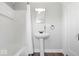 Modern bathroom featuring a pedestal sink and a shower/tub with white subway tiles at 606 E County Line Rd, Indianapolis, IN 46227