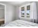 Cozy bedroom with neutral walls, sheer curtains, and natural light coming through the windows at 606 E County Line Rd, Indianapolis, IN 46227