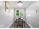Cozy dining room with a modern chandelier and a large window with natural light at 606 E County Line Rd, Indianapolis, IN 46227