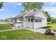 Charming home exterior with well-maintained lawn, landscaping, and white painted siding at 606 E County Line Rd, Indianapolis, IN 46227
