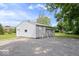 Detached two car garage with white painted siding and an extra parking area at 606 E County Line Rd, Indianapolis, IN 46227