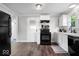 Modern kitchen with white cabinets, black appliances, and hardwood floors at 606 E County Line Rd, Indianapolis, IN 46227