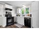 Updated kitchen with sleek black appliances, white cabinets, and modern countertops at 606 E County Line Rd, Indianapolis, IN 46227