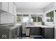 Bright laundry room features updated washer and dryer plus ample counter space and storage at 606 E County Line Rd, Indianapolis, IN 46227