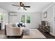 Sunlit living room featuring comfortable seating, modern fixtures, and dark wood-look flooring at 606 E County Line Rd, Indianapolis, IN 46227
