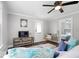 Bright living room with wood floors and a ceiling fan offers a view into an adjacent bedroom at 606 E County Line Rd, Indianapolis, IN 46227