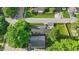 A bright aerial view of a tree lined neighborhood highlighting a home with a great lawn at 6102 Primrose Ave, Indianapolis, IN 46220