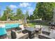 Back deck showcases wicker seating around a fire pit with plush, light blue cushions at 6102 Primrose Ave, Indianapolis, IN 46220