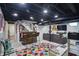 Finished basement featuring a bar area, a sofa with play area, and modern recessed lighting at 6102 Primrose Ave, Indianapolis, IN 46220