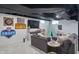 Finished basement featuring a comfortable sectional sofa, a play area, and walls decorated with sports memorabilia at 6102 Primrose Ave, Indianapolis, IN 46220