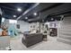The finished basement includes a sectional sofa, a play area, and recessed lighting at 6102 Primrose Ave, Indianapolis, IN 46220
