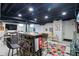 Finished basement features a bar area, a sofa with play area, and modern recessed lighting at 6102 Primrose Ave, Indianapolis, IN 46220